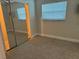 Bedroom featuring windows with blinds, mirrored closet, and tiled floors at 5106 Gateway Dr, Tampa, FL 33615
