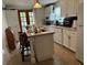 Well-lit kitchen featuring white cabinets, modern appliances, and a charming tile-top island with seating at 5106 Gateway Dr, Tampa, FL 33615