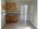 Kitchenette featuring cabinets, sink, countertops, and tiled floors at 5106 Gateway Dr, Tampa, FL 33615