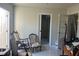 Spacious room featuring antique chairs and rocking chairs, with three doorways leading to other rooms at 5106 Gateway Dr, Tampa, FL 33615