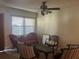 Bright living room with a ceiling fan and vintage furniture, including an antique chaise lounge at 5106 Gateway Dr, Tampa, FL 33615