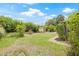 Backyard featuring large grassy area, shed, and mature foliage at 5821 52Nd N Ave, Kenneth City, FL 33709