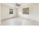 Bright bedroom features a ceiling fan and two windows, providing plenty of natural light at 5821 52Nd N Ave, Kenneth City, FL 33709