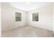 Simple bedroom with neutral walls, two bright windows, and closet with shelving at 5821 52Nd N Ave, Kenneth City, FL 33709