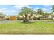 Charming single-story home with driveway, manicured lawn, and mature trees at 5821 52Nd N Ave, Kenneth City, FL 33709