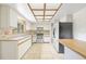 Well-lit kitchen with a tiled floor, wooden countertops, and white cabinetry at 5821 52Nd N Ave, Kenneth City, FL 33709