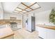 Spacious kitchen featuring tiled floors, white cabinets, and modern appliances at 5821 52Nd N Ave, Kenneth City, FL 33709