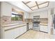 Traditional kitchen features tile backsplash, stainless steel oven, and a sunlit window above the sink at 5821 52Nd N Ave, Kenneth City, FL 33709