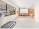 Bright living room features a large window, movie screen, and wood accent wall at 5821 52Nd N Ave, Kenneth City, FL 33709