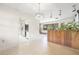 Bright living area with open access to the kitchen, featuring terrazzo flooring and wood accents at 5821 52Nd N Ave, Kenneth City, FL 33709