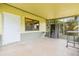 Covered patio featuring neutral paint, tile flooring, and a door to the backyard at 5821 52Nd N Ave, Kenneth City, FL 33709