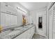 Elegant bathroom featuring double sinks with granite countertops and bright vanity lighting at 602 Hillpoint Way, Brandon, FL 33510