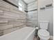 Bright bathroom featuring a tiled bathtub and a sleek, modern toilet at 602 Hillpoint Way, Brandon, FL 33510