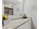 Bathroom features a decorative mirror, granite countertops, and modern fixtures at 602 Hillpoint Way, Brandon, FL 33510