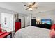 A modern bedroom with a ceiling fan, closet, and view to the entryway and en suite bathroom at 602 Hillpoint Way, Brandon, FL 33510