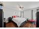 Comfortable bedroom featuring a ceiling fan, wood-look floors, and a cozy decorative color scheme at 602 Hillpoint Way, Brandon, FL 33510