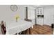 Charming dining area features modern light fixtures, wood floors and kitchen access at 602 Hillpoint Way, Brandon, FL 33510
