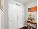 Entryway featuring double doors, a small table, and an American flag at 602 Hillpoint Way, Brandon, FL 33510