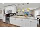 Spacious kitchen features stainless steel appliances, granite counters, and modern white cabinetry at 602 Hillpoint Way, Brandon, FL 33510