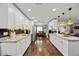 Open kitchen with wood floors, white cabinets, stainless appliances, and eat-in dining area at 602 Hillpoint Way, Brandon, FL 33510