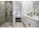 Bright bathroom with a walk-in shower and double sink vanity at 6206 64Th N Way, Pinellas Park, FL 33781