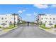 Community entrance showcasing modern townhomes and gated access, promoting security and upscale living at 6206 64Th N Way, Pinellas Park, FL 33781