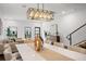 Bright dining area features modern light fixture, dining table, and flows into living room at 6206 64Th N Way, Pinellas Park, FL 33781