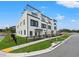 Stylish townhouse featuring a contemporary design, well-maintained landscaping, and black metal fencing at 6206 64Th N Way, Pinellas Park, FL 33781