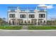 Modern townhouse with rooftop terrace, showcasing sleek design and a cozy front yard with decorative accents at 6206 64Th N Way, Pinellas Park, FL 33781