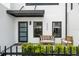 Inviting front porch with modern seating, decorative plants, and contemporary entrance enhancing curb appeal at 6206 64Th N Way, Pinellas Park, FL 33781
