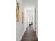 Hallway leading to a bedroom with hardwood floors and decorative art at 6206 64Th N Way, Pinellas Park, FL 33781