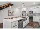Kitchen with white cabinets, quartz countertops, stainless steel appliances and center island at 6206 64Th N Way, Pinellas Park, FL 33781