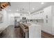Modern kitchen featuring white cabinetry, stainless steel appliances, and a spacious island with seating at 6206 64Th N Way, Pinellas Park, FL 33781