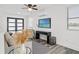 Modern living room with sleek floors, black console, TV, and comfortable seating at 6206 64Th N Way, Pinellas Park, FL 33781