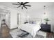 Modern main bedroom with neutral color palette, geometric rug, and updated ceiling fan at 6206 64Th N Way, Pinellas Park, FL 33781