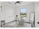 Bright office with closet, large window, glass desk, modern chair, and accent mirror at 6206 64Th N Way, Pinellas Park, FL 33781