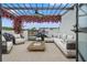 Picturesque outdoor patio featuring a pergola, comfortable seating, and vibrant floral accents at 6206 64Th N Way, Pinellas Park, FL 33781