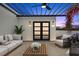 Stylish outdoor patio with a pergola, ceiling fan, comfortable seating, and lush greenery at 6206 64Th N Way, Pinellas Park, FL 33781