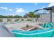 Pool area boasts an umbrella, palm trees, lounge chairs, and seating areas for relaxing and entertaining at 6206 64Th N Way, Pinellas Park, FL 33781