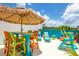 Fun rooftop deck area with a tiki bar and colorful seating perfect for social gatherings and enjoying the summer sun at 6206 64Th N Way, Pinellas Park, FL 33781