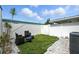Relaxing backyard featuring well-maintained turf, white rock, and comfortable seating, perfect for enjoying the outdoors at 6212 S Adelia Ave, Tampa, FL 33616
