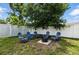 The backyard offers a cozy seating area with a fire pit, perfect for relaxing and entertaining guests at 6212 S Adelia Ave, Tampa, FL 33616