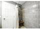 Updated bathroom features a stylish tiled shower with a wooden bench and modern fixtures at 6212 S Adelia Ave, Tampa, FL 33616