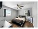Comfortable bedroom featuring hardwood floors, natural light from two windows, and modern decor at 6212 S Adelia Ave, Tampa, FL 33616