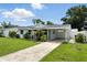 Charming single-story home with a well-manicured lawn, carport, and inviting curb appeal at 6212 S Adelia Ave, Tampa, FL 33616