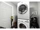 Efficient laundry area with stacked washer and dryer units for space-saving convenience at 6212 S Adelia Ave, Tampa, FL 33616