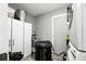 The laundry room offers ample cabinet space, modern appliances, and room for cleaning and storage at 6212 S Adelia Ave, Tampa, FL 33616