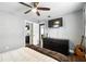 Serene main bedroom with a ceiling fan, TV, closet, and modern decor at 6212 S Adelia Ave, Tampa, FL 33616