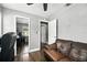 Bright home office featuring hardwood floors, a leather sofa, and a mirrored closet at 6212 S Adelia Ave, Tampa, FL 33616