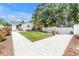 Spacious backyard with white rock border, manicured lawn, patio and pergola-covered dining area at 650 63Rd S Ave, St Petersburg, FL 33705